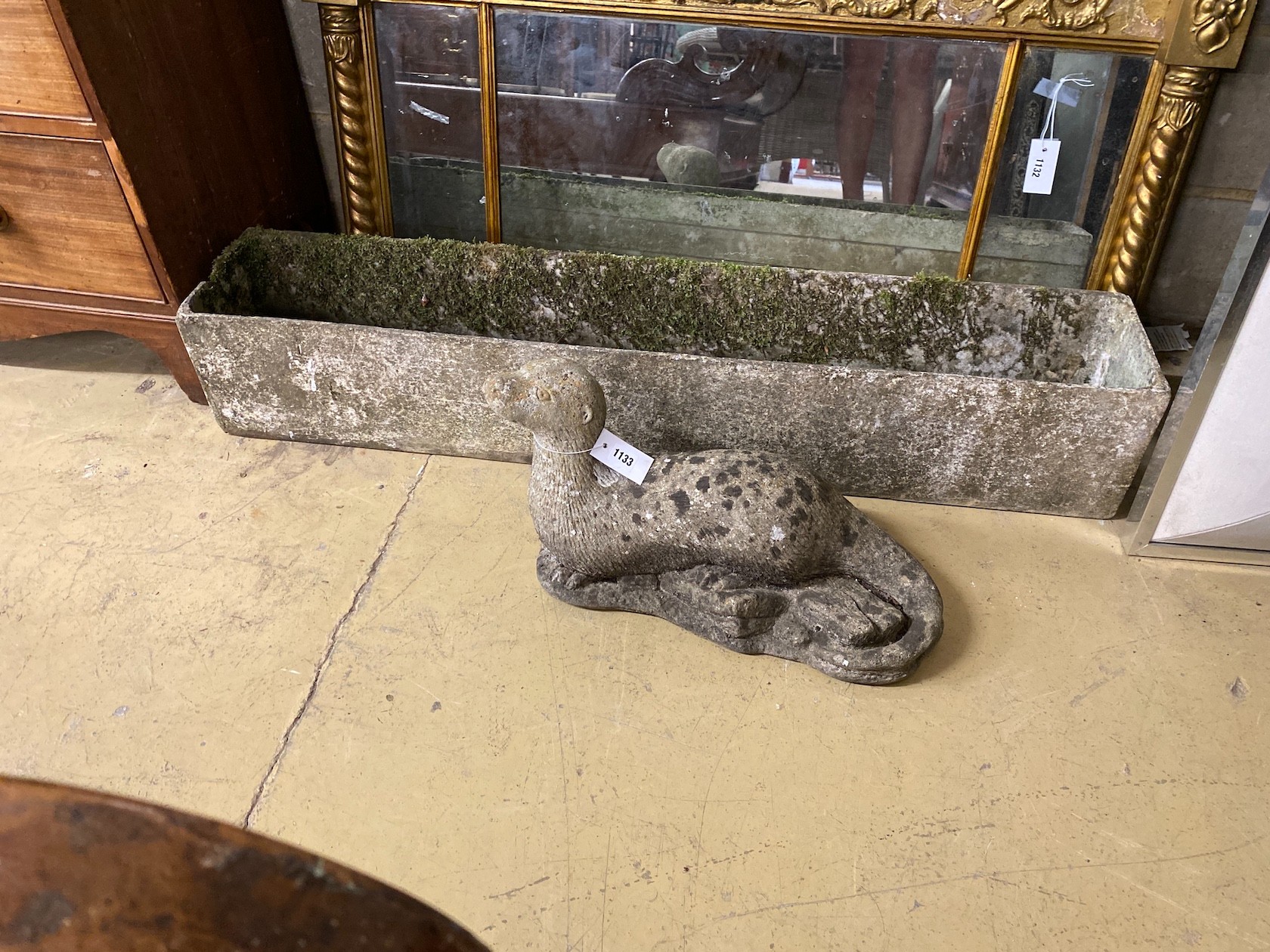 A rectangular garden planter, length 121cm together with a reconstituted stone otter garden ornament, height 29cm